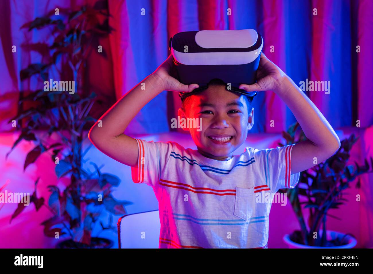 Little kid boy experiencing virtual reality goggles experiencing reality Stock Photo