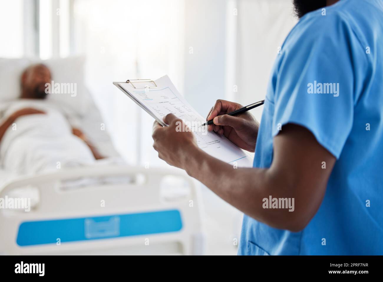 Healthcare, insurance and hospital plan by medical intern writing and filling out form. Health care professional doing admin, keep record of sick patient medication and treatment in a hospital Stock Photo