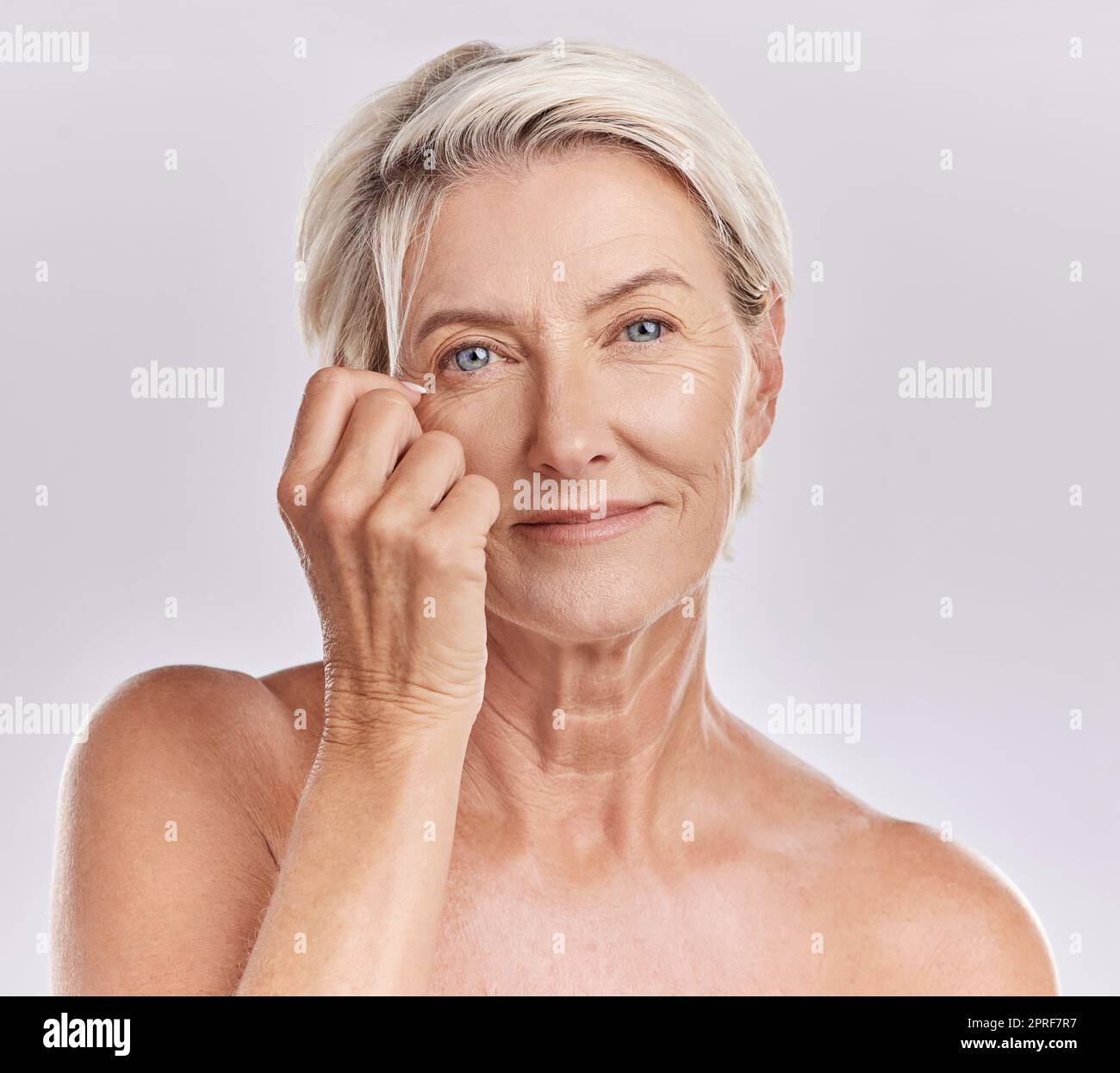 Skincare Health And Hair Care With A Senior Woman In Studio On A Grey skincare-health-and-hair-care-with-a-senior-woman-in-studio-on-a-grey