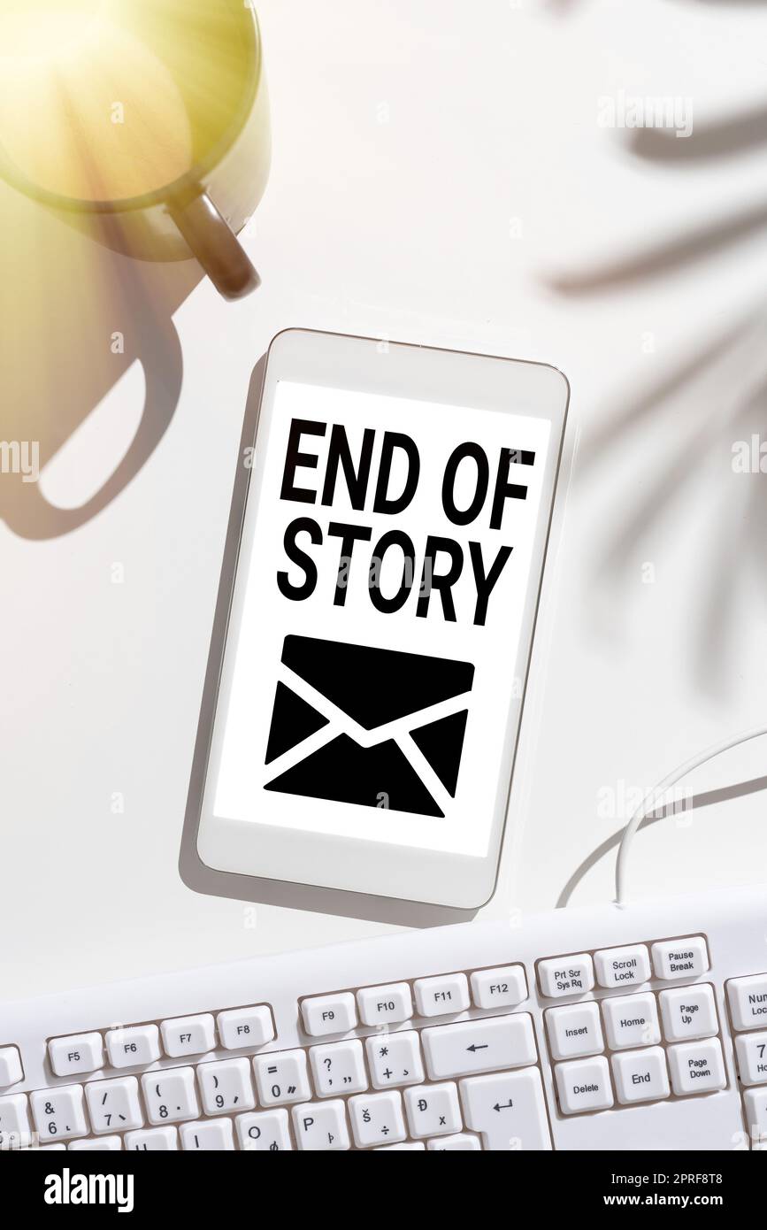 Text showing inspiration End Of Story. Conceptual photo Emphasize that nothing to add Literature writing Journalism Mobile Phone Screen With Important Message On Desk With Coffee And Keyboard Stock Photo