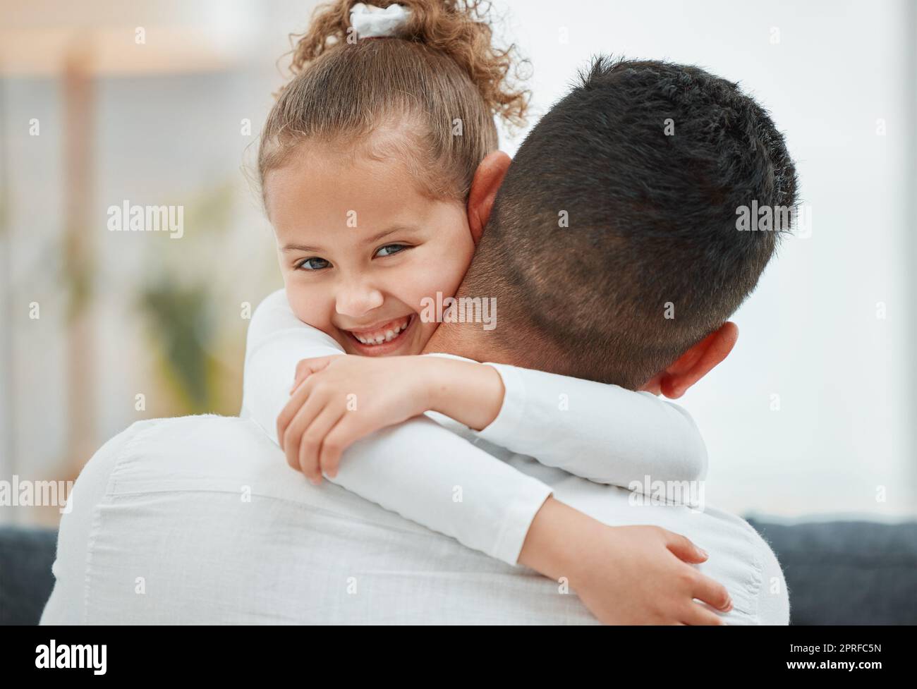 Feeling safe and secure in your arms. a little girl being held by her