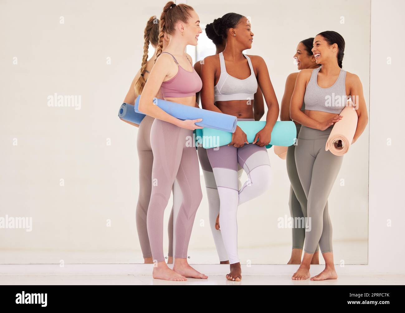 happy group of people of three women practicing yoga in the studio