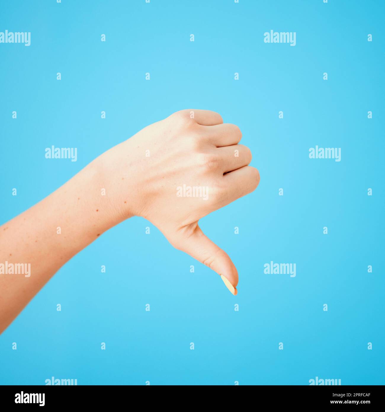 Nope, not for me. Studio shot of an unrecognisable woman showing thumbs down against a blue