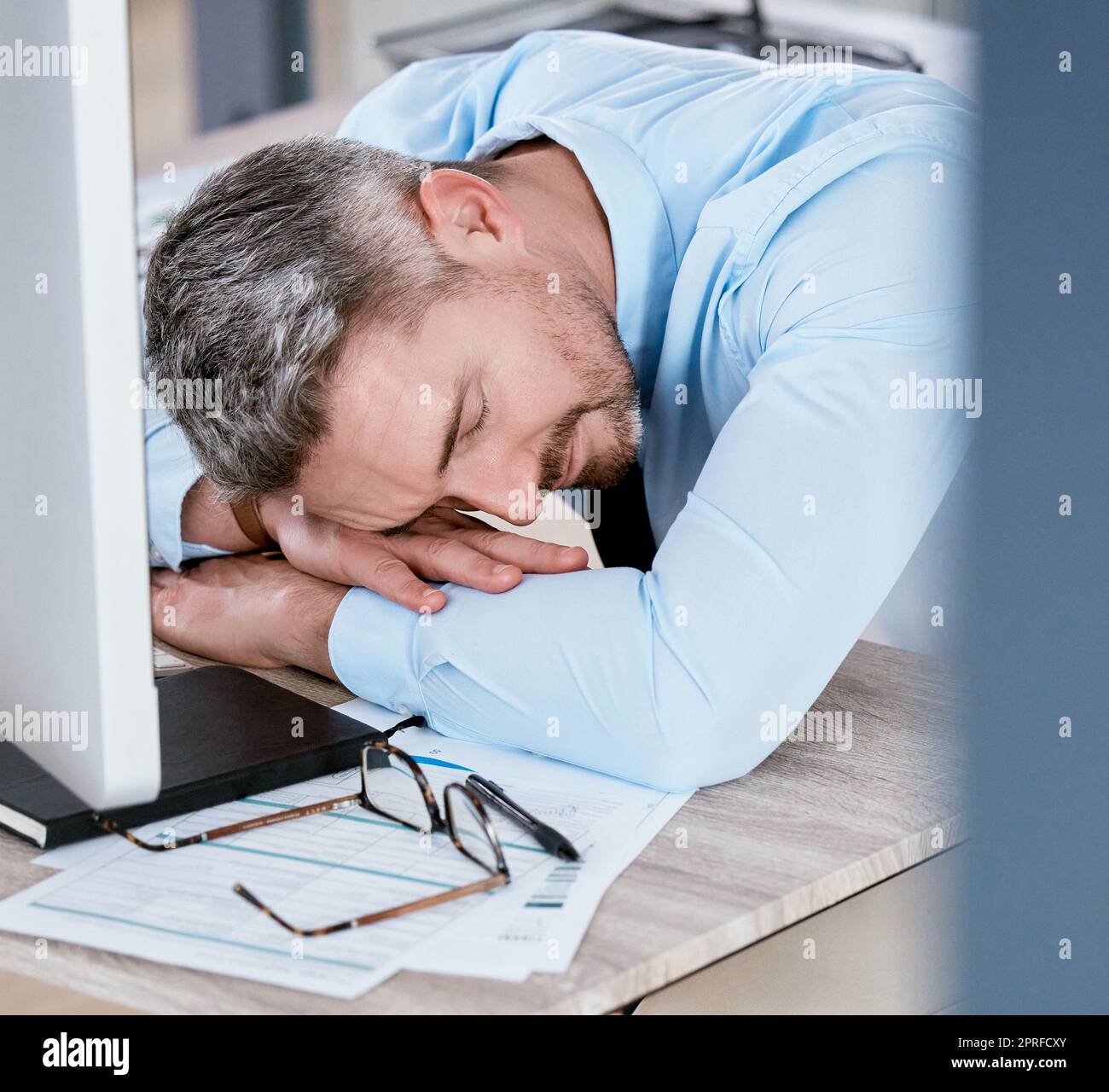 Hard work is too tiring. a mature businessman sleeping at his desk in an office Stock Photo