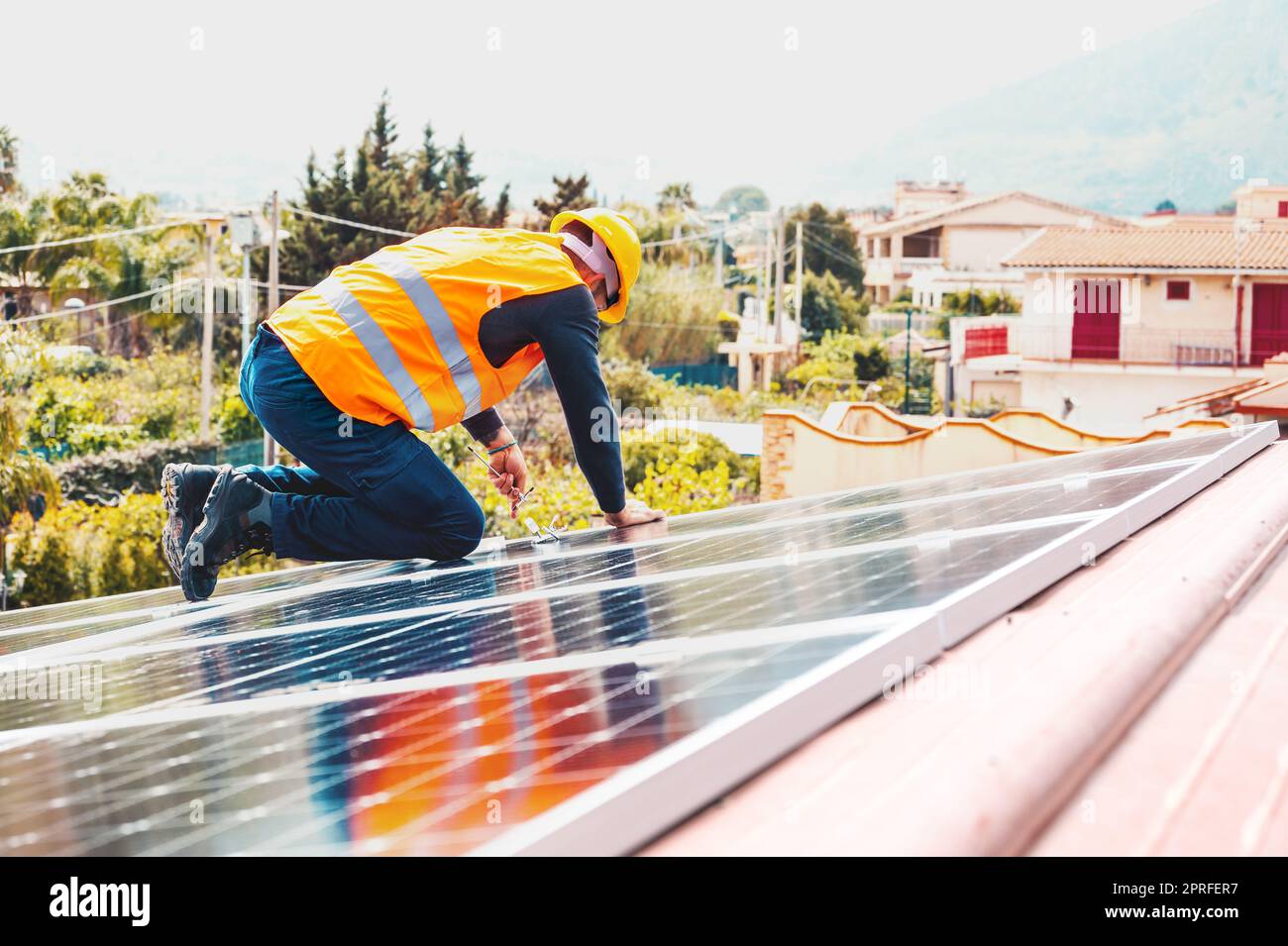 Workers assemble energy system with solar panel for electricity Stock