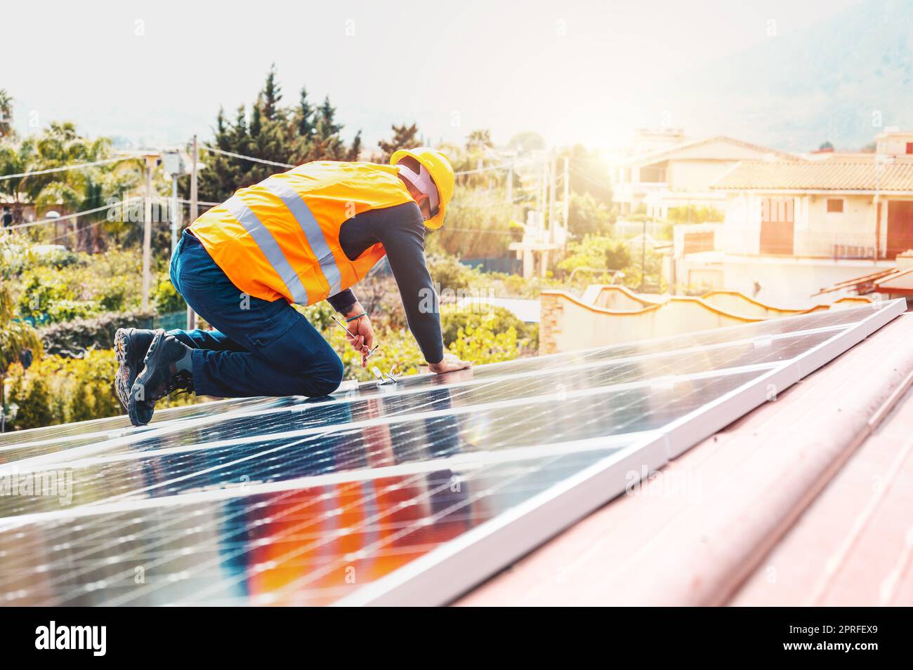 Workers assemble energy system with solar panel for electricity Stock Photo