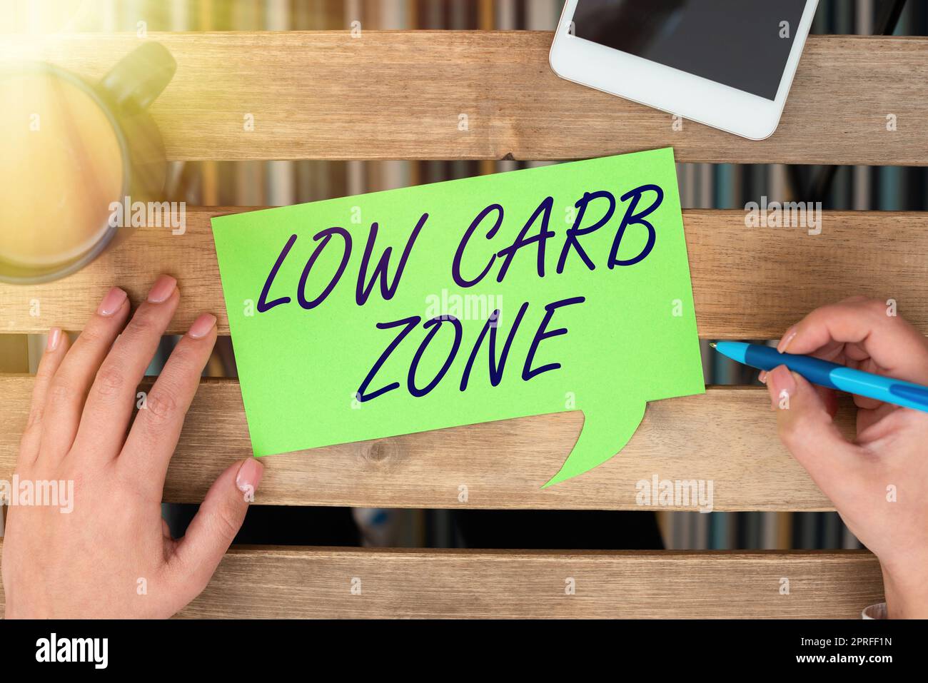 Text showing inspiration Low Carb Zone. Business overview Healthy diet for losing weight eating more proteins sugar free Woman Holding Pen And Presenting Important Message On Speech Bubble. Stock Photo
