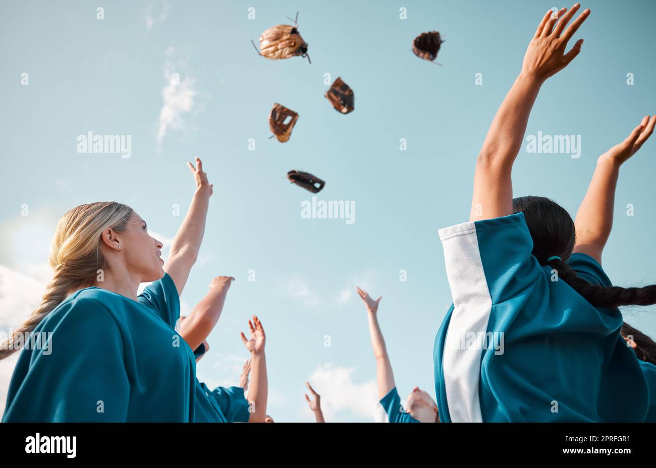 Winning team, sports celebration and baseball women group throwing gloves in air for goal victory and feeling happy after game or match. Teamwork, sof Stock Photo