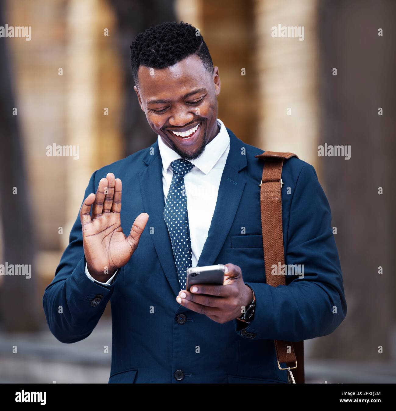 Young African businessman video call on smartphone, outside company office building and communication in city. Portrait of entrepreneur on social media, 5g internet connection with mobile technology. Stock Photo