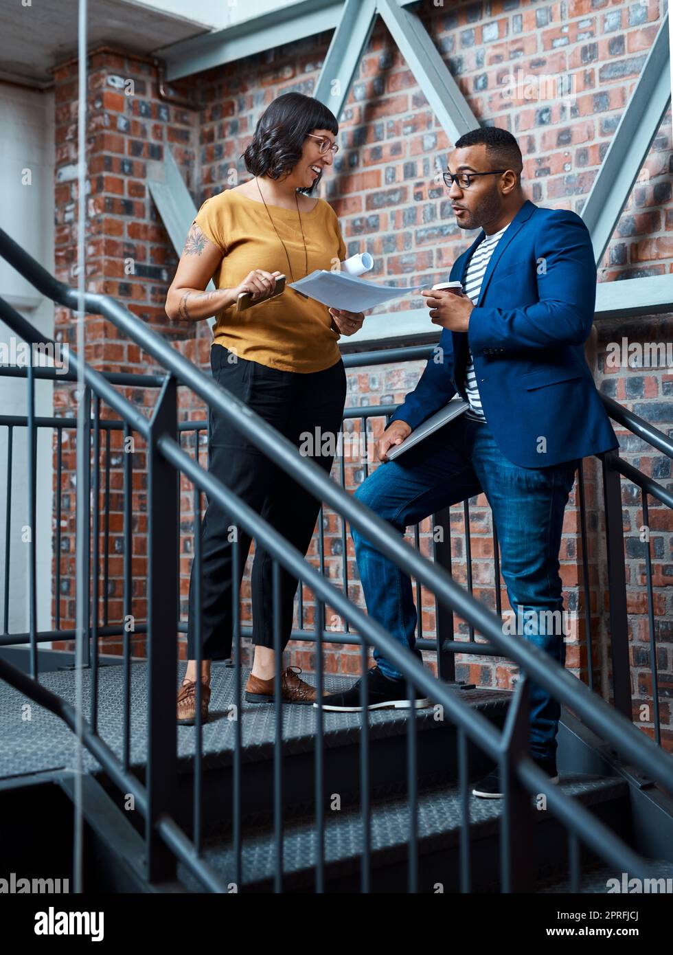 Theyve got a knack for creating winning concepts. two young designers having a discussion in an office. Stock Photo