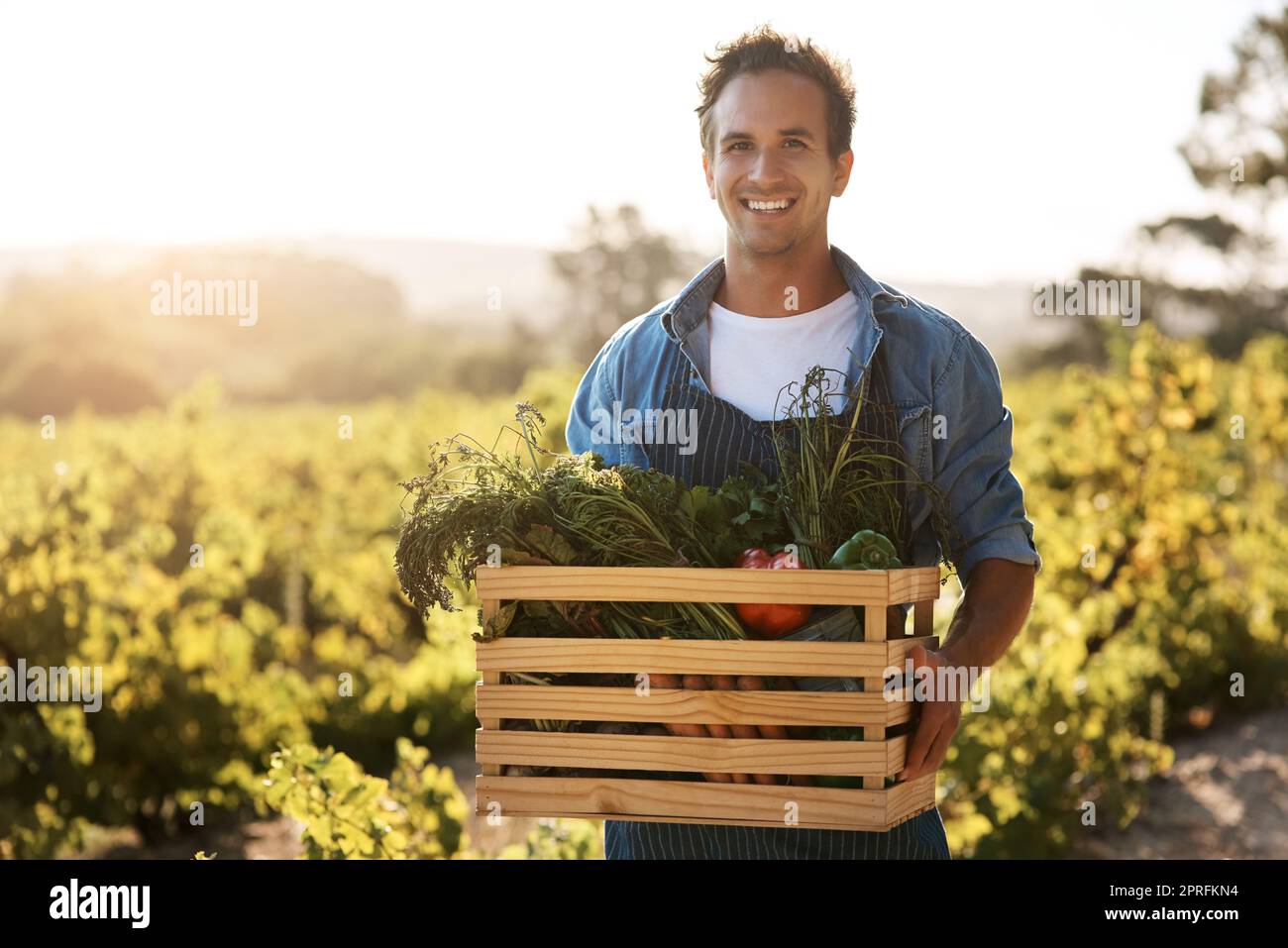 Enjoy fresh, healthy, locally grown produce. a young man holding a