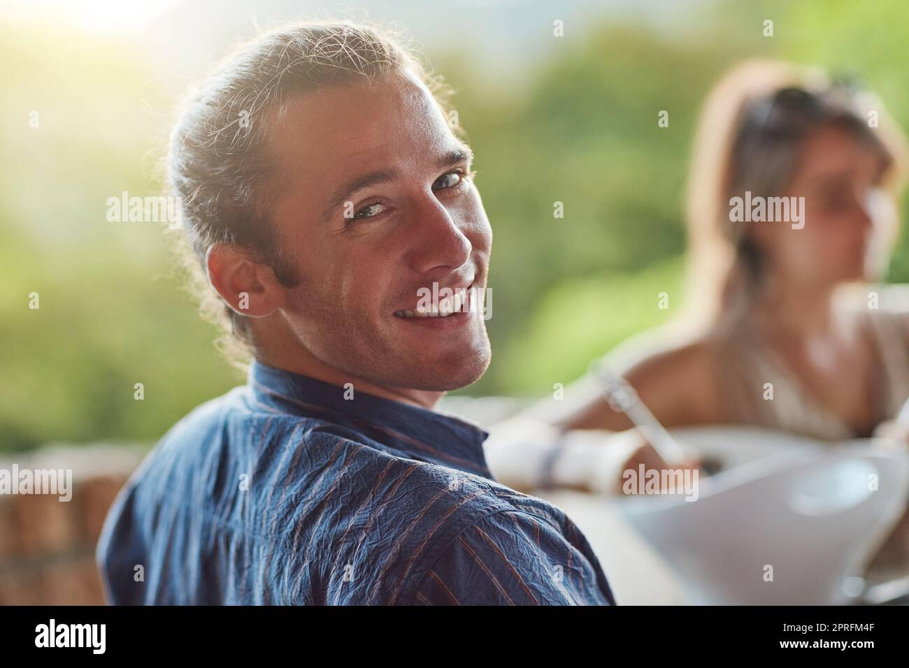 I couldnt ask for better friends. Portrait of a happy young man sharing a meal with friends at an outdoor dinner party. Stock Photo
