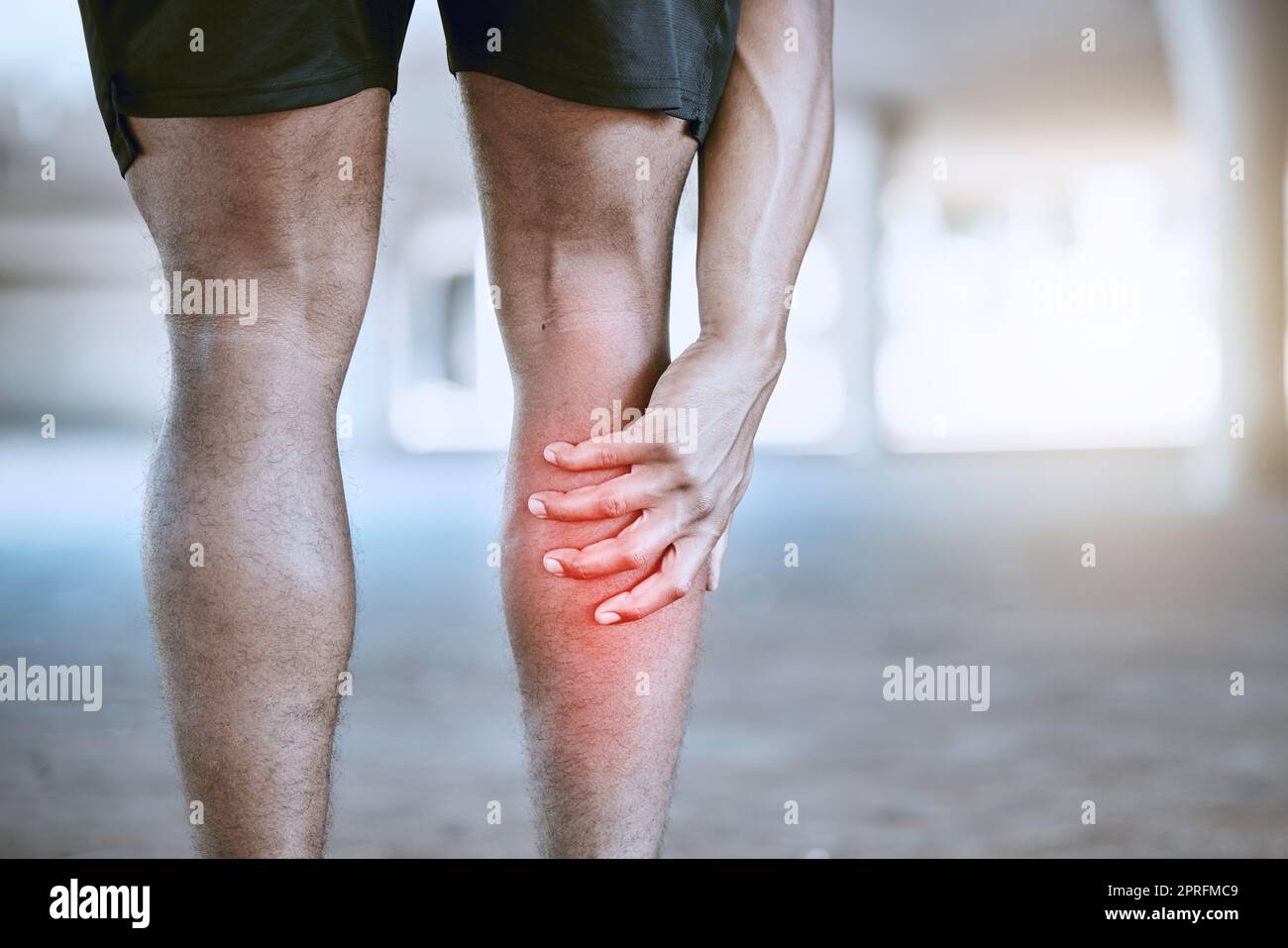 Sports man hand on a leg injury while training, exercise or workout