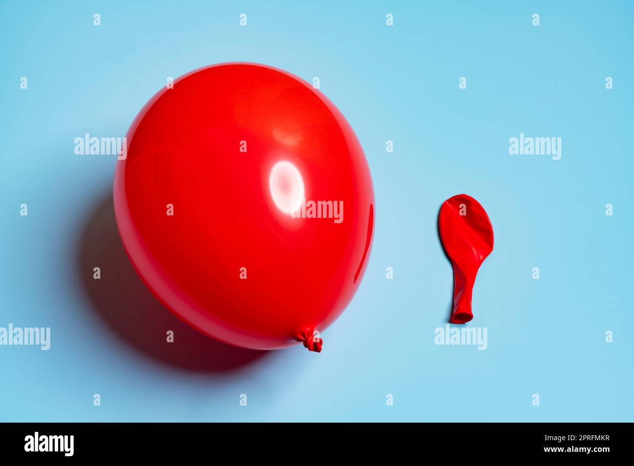 one inflated and one deflated red balloons side by side Stock Photo Alamy
