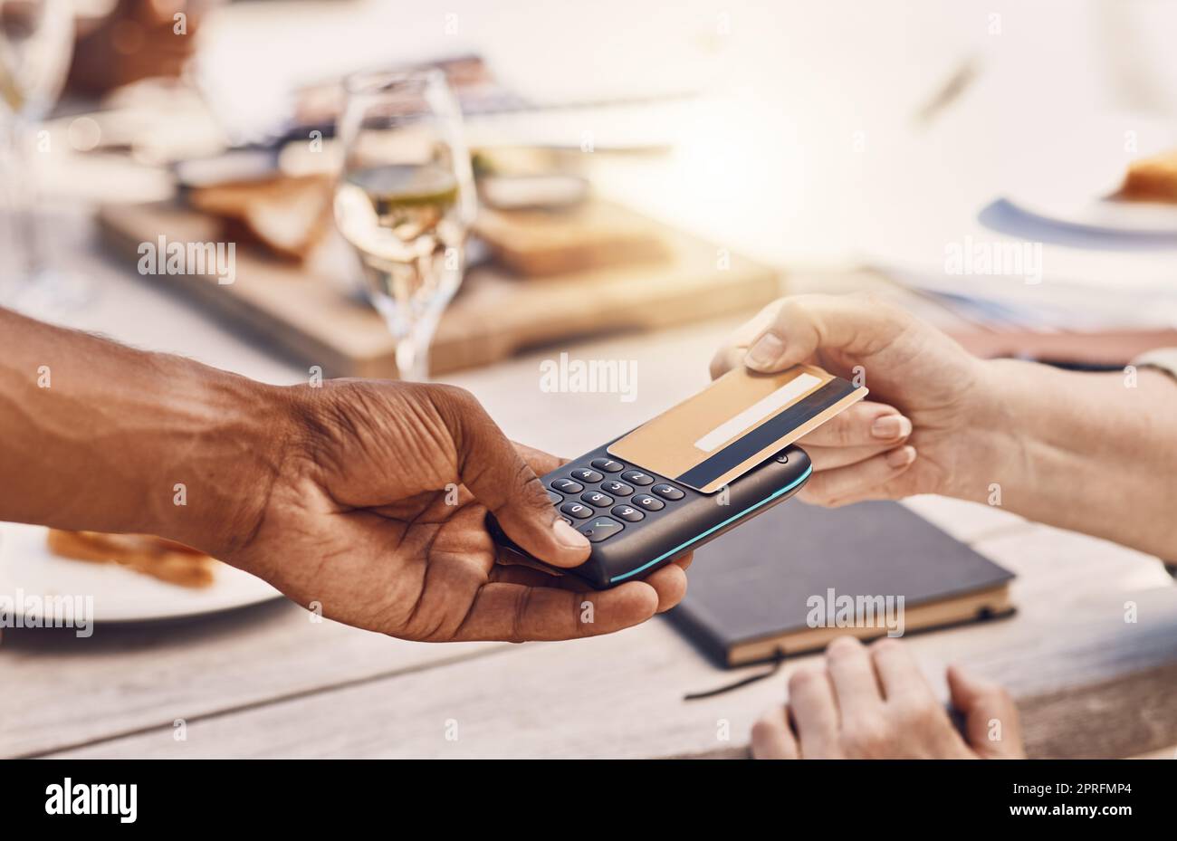 Restaurant customer payment with credit card on machine or digital tech for contactless and secure payment while fine dining. Food business manager or waiter hands using 5g to tap or scan a bank card Stock Photo