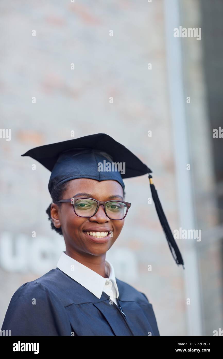 Graduating with honours. Portrait of a happy female student standing