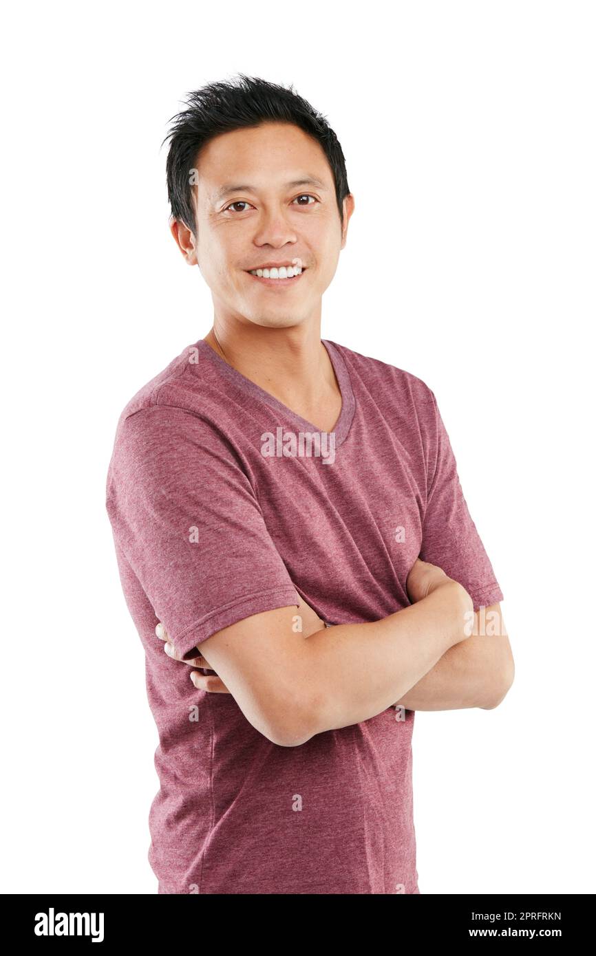 Hes not camera shy. Studio portrait of a young man posing with his arms folded against a white background. Stock Photo