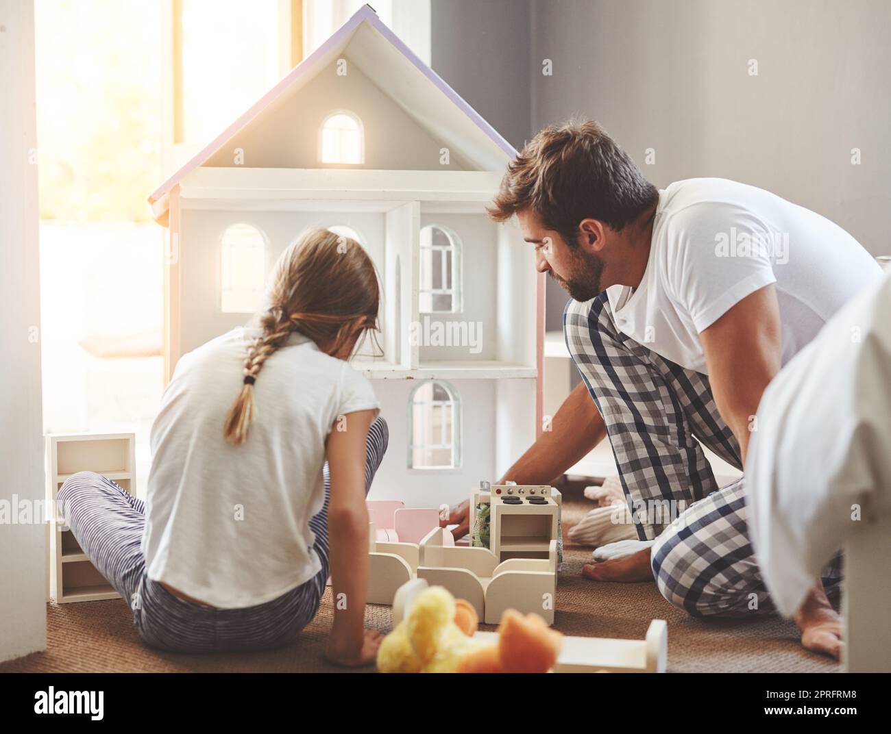 Get to know your children by playing with them. a father spending quality time with his little daughter at home. Stock Photo