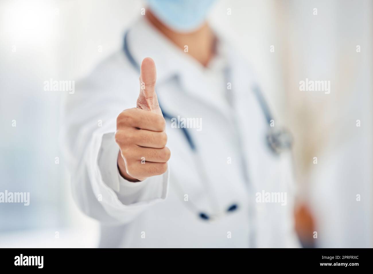 Medical doctors hand show thumbs up for success or goal working at a