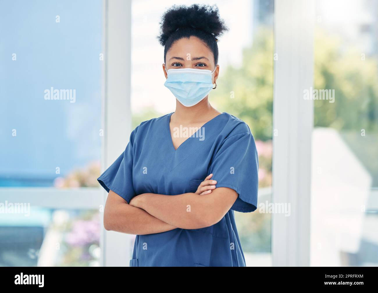 Nurse, healthcare black woman with a covid face mask in confident portrait. Innovation, leadership and proud medical nursing professional, surgeon or health employee with vision for success in career Stock Photo