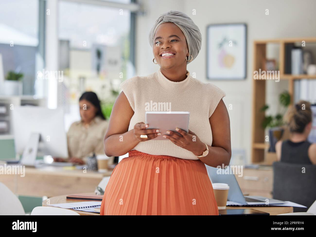 Tablet, work and happy smile of a Muslim black woman in a digital marketing office. International, global and diversity of company with a web market tech worker from Senegal with Islamic hair wrap Stock Photo