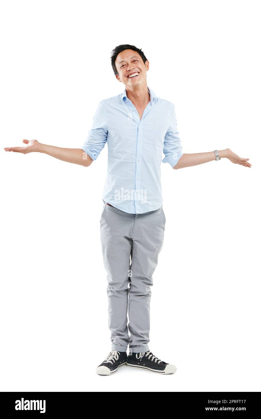 Im cool either way. Studio portrait of a happy young man shrugging against a white background. Stock Photo