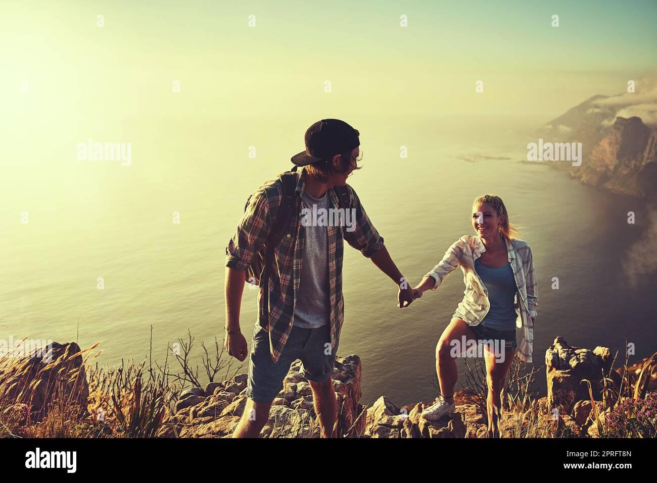 Theyve got a double case of wanderlust. an affectionate young couple bonding while out on a hike together. Stock Photo