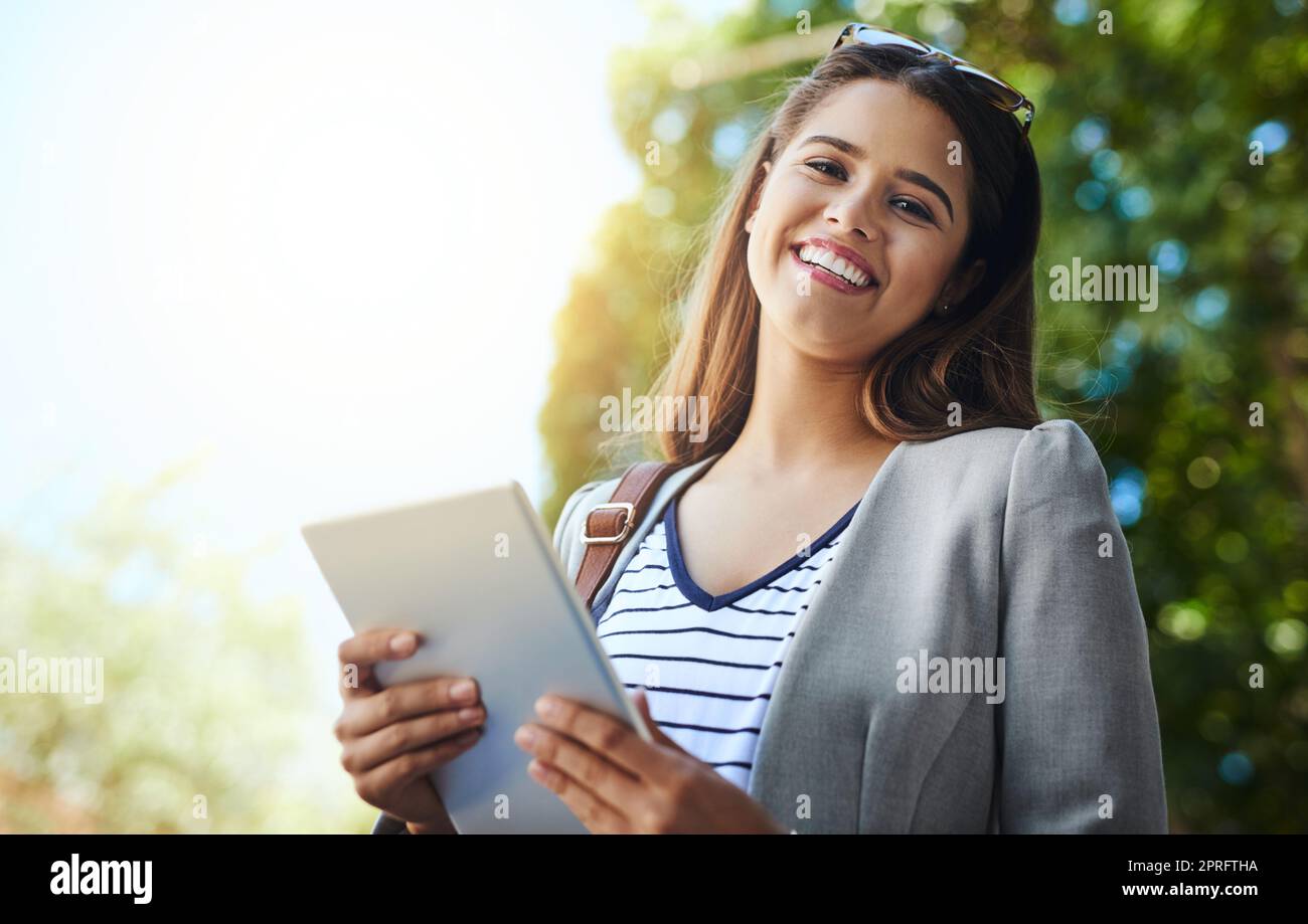 Now Im connected wherever I go. Cropped portrait of an attractive young woman using her tablet while commuting to work. Stock Photo