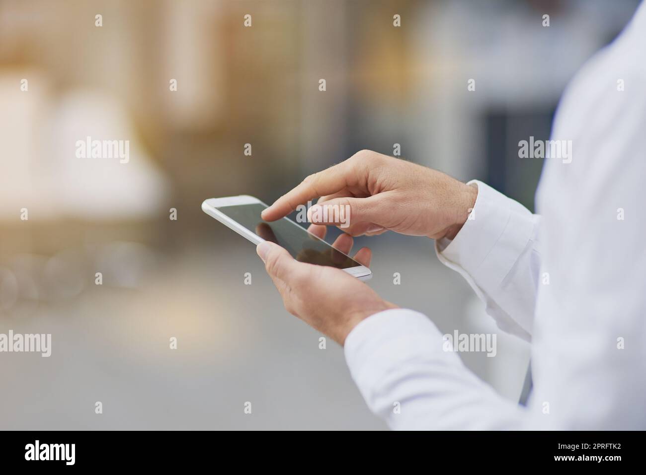 Sending out an update. an unrecognizable businessman using his cellphone. Stock Photo
