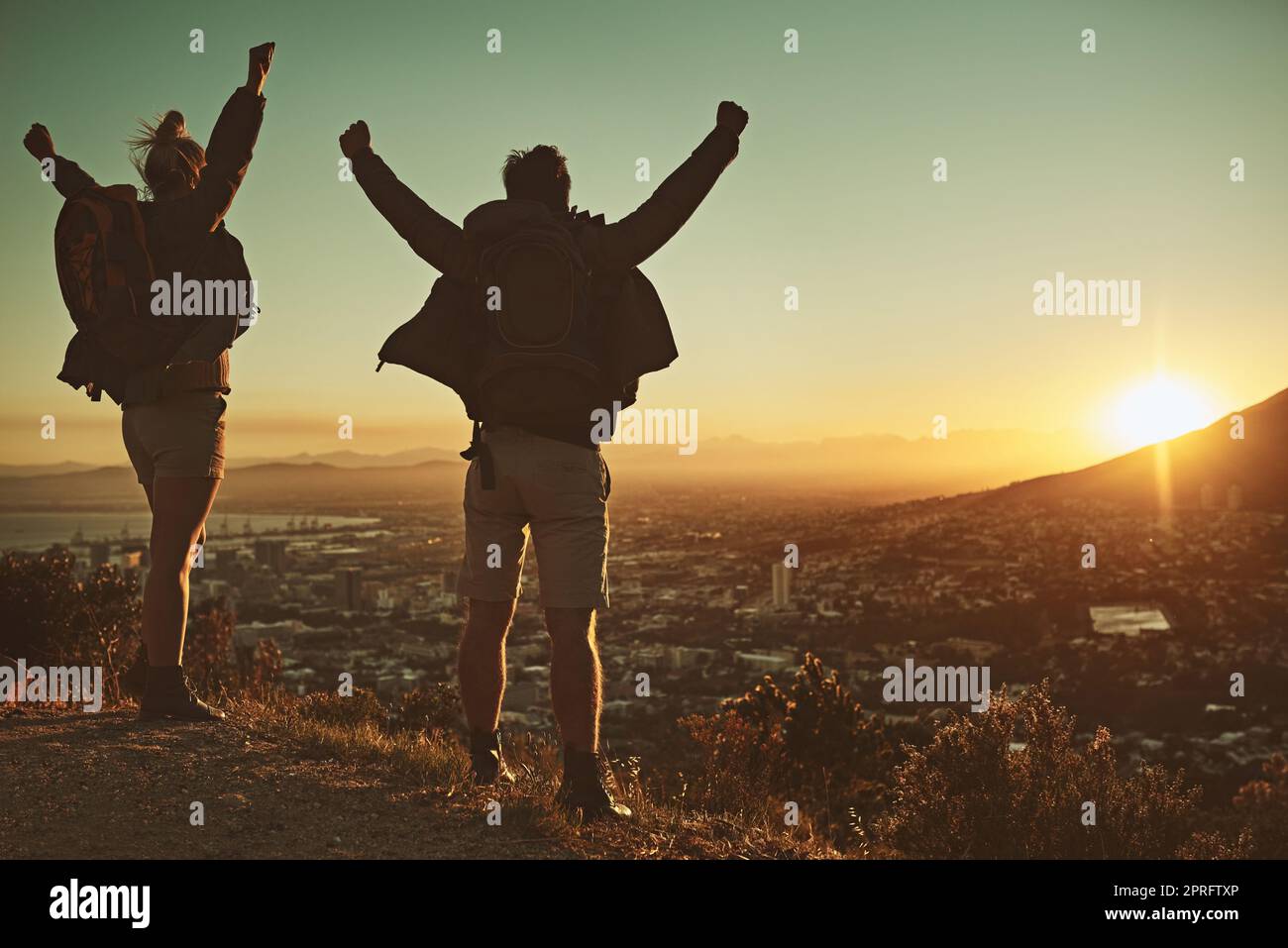 Achieving their trail goals. a couple celebrating after reaching the summit. Stock Photo