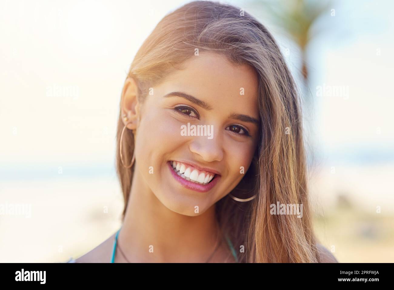 The beach is the only place I need to be. Portrait of an attractive young woman standing outside on a sunny day. Stock Photo