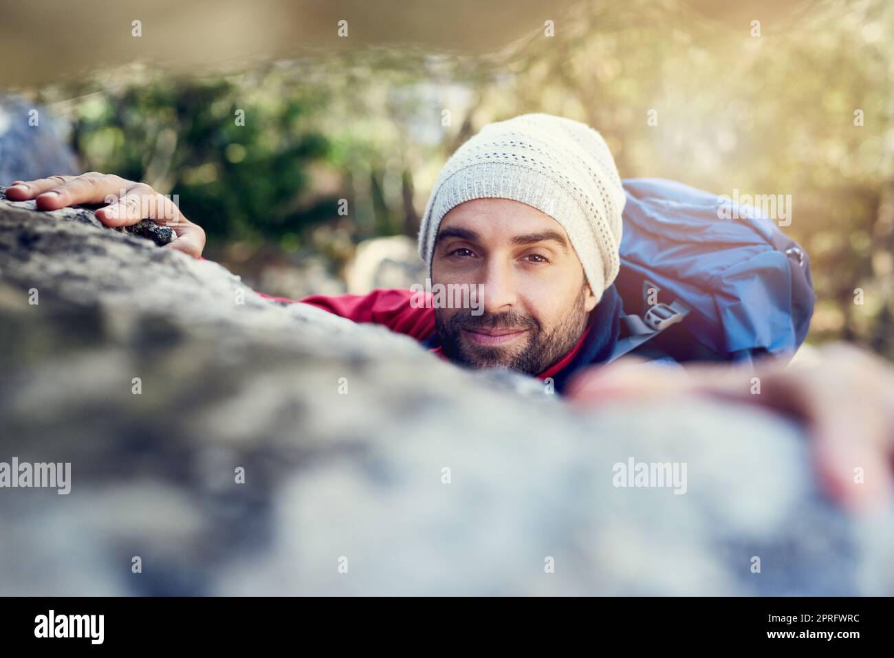Climb every mountain, ford every stream. Portrait of a happy hiker ...