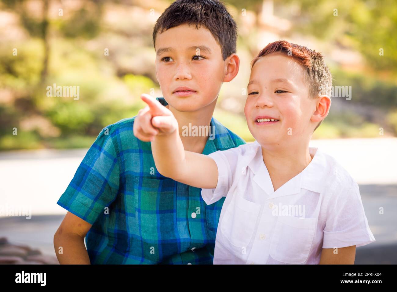 Outdoor portrait of biracial Chinese and Caucasian brothers Stock Photo