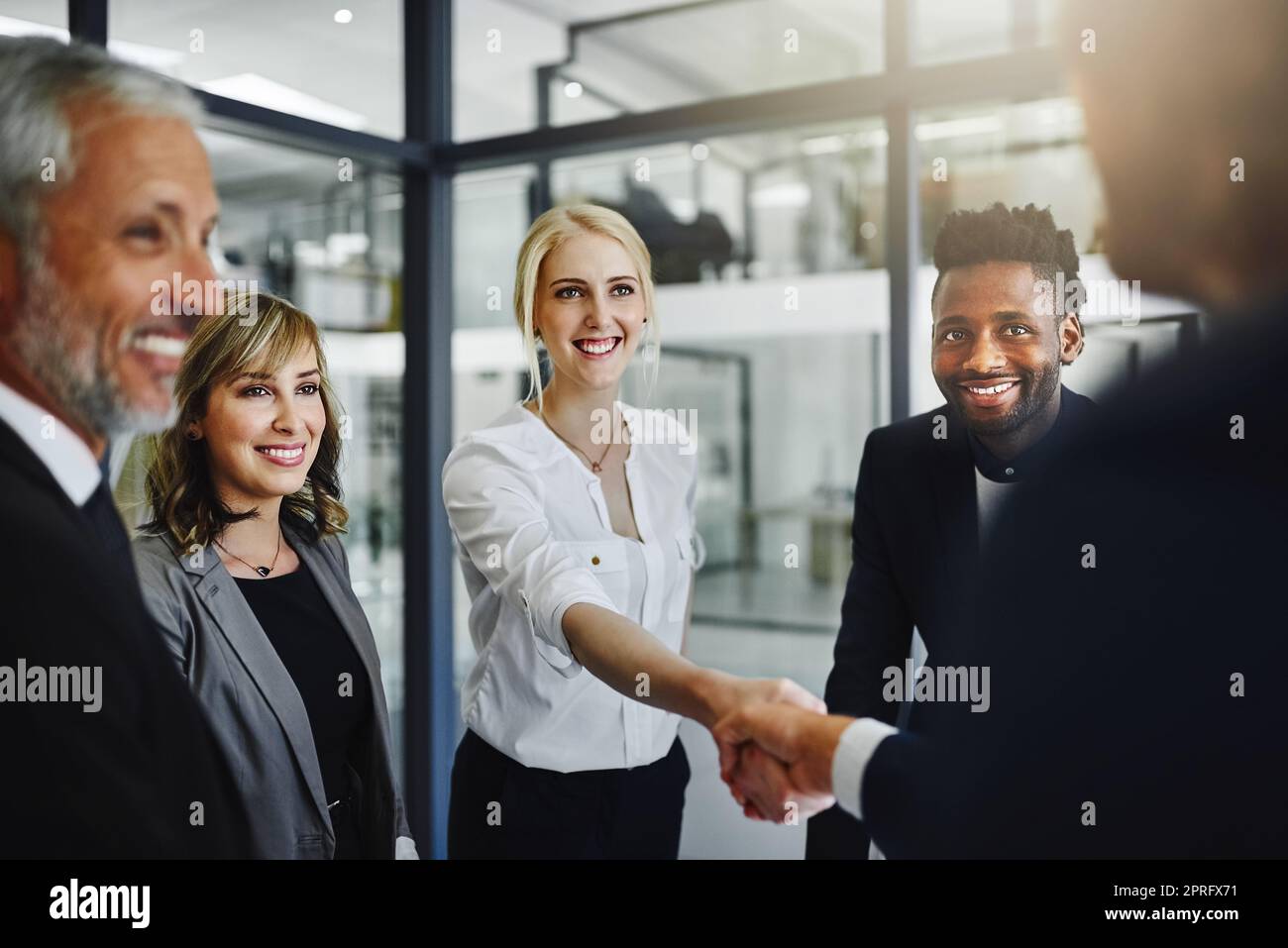 Well no doubt work very well together. businesspeople shaking hands in an office. Stock Photo