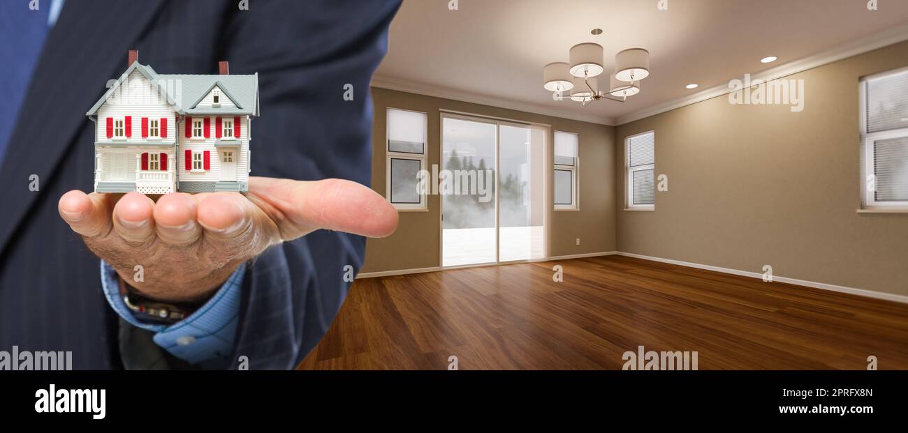 Real Estate Agent Holding Model Home In New Room of House Stock Photo ...
