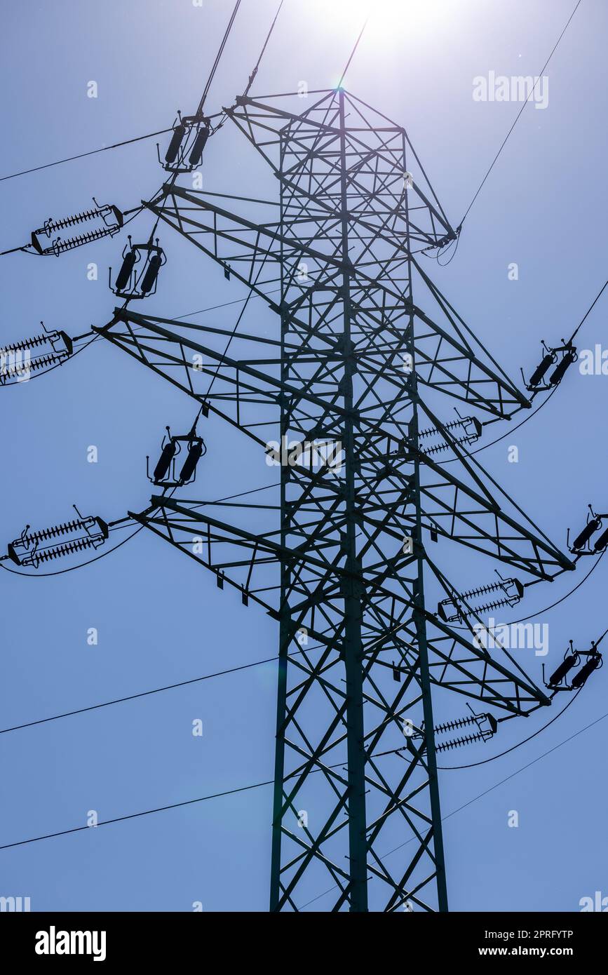 high voltage power pole and lines against the blue sky Stock Photo - Alamy