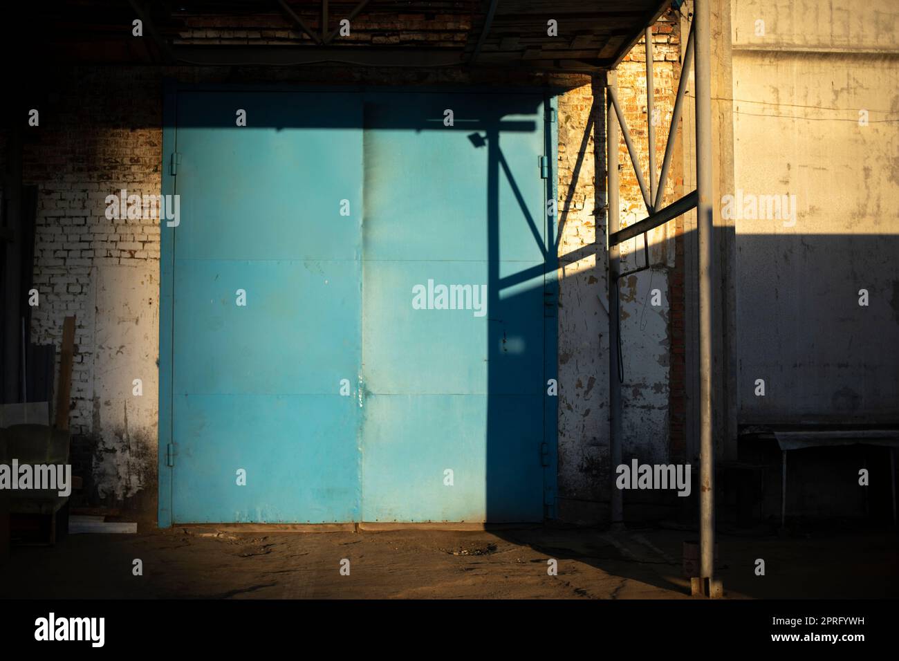 Gate to large garage. Blue gate to warehouse. Industrial zone Stock