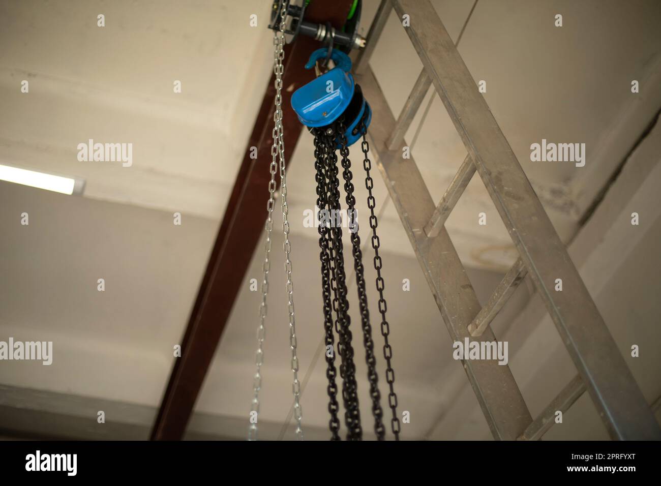 Chain on ceiling. Chains hang on steel beam. Stock Photo