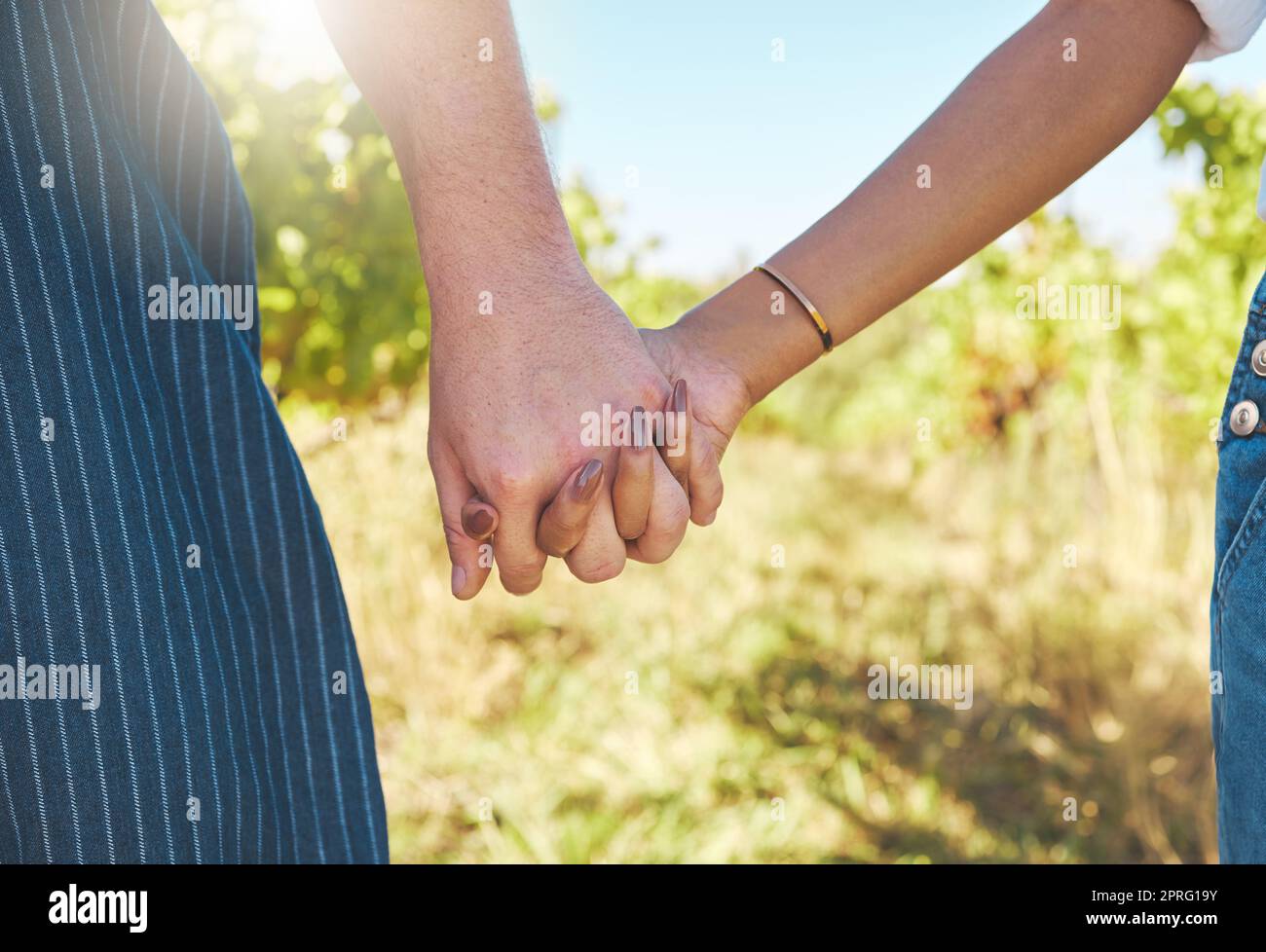 Love, support and couple of people holding hands in solidarity. Respect, trust and unity in relationship with partner. Woman and man happy with romantic and caring partnership together. Stock Photo