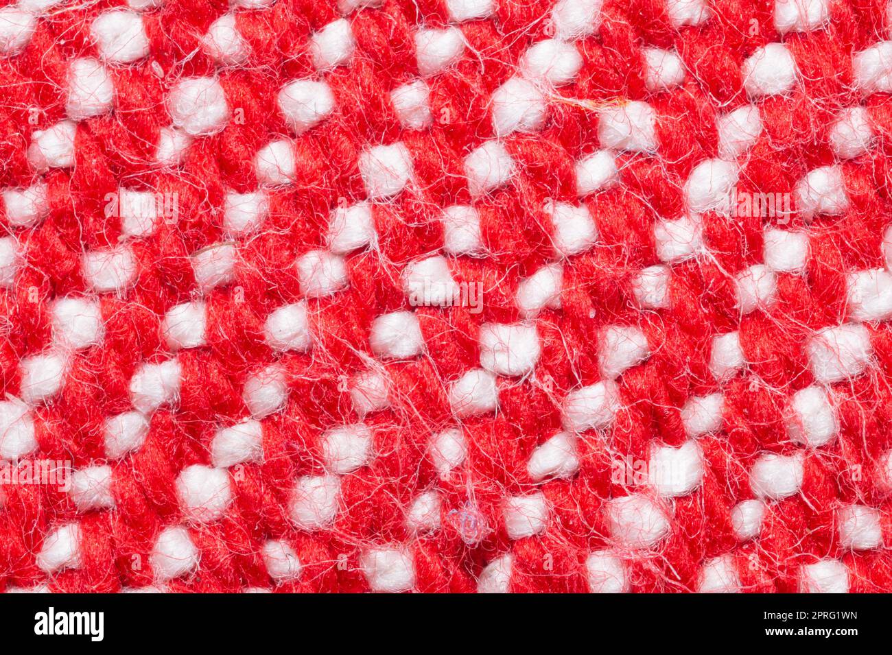 Handmade knitted fabric. red and white woolen background Stock Photo