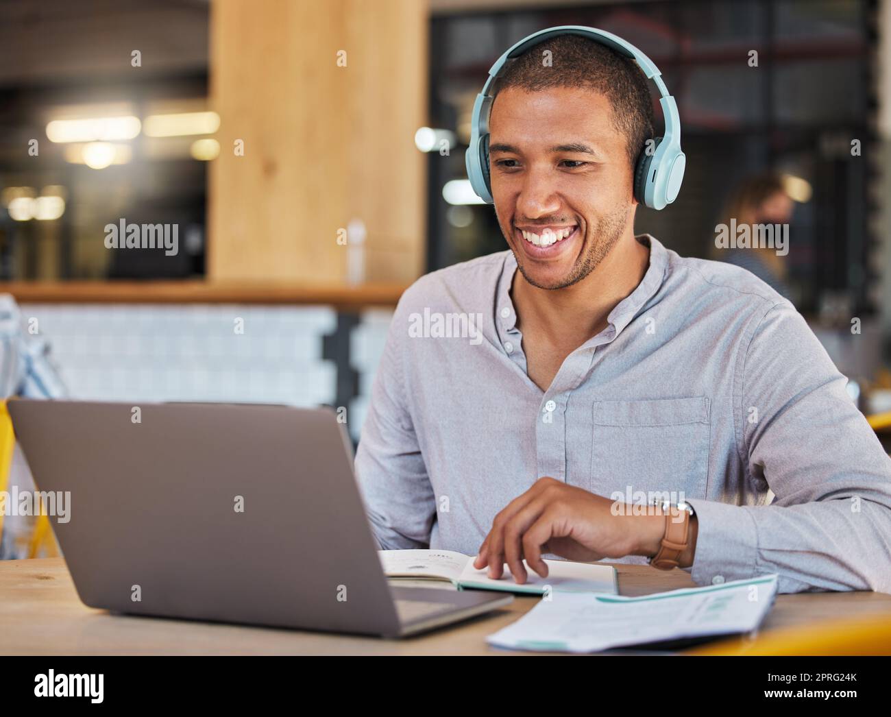 Laptop webinar, workshop training or zoom call meeting in cafe, restaurant or coffee shop with paper. Learning student or headphones man listening to video conference or mentor education presentation Stock Photo