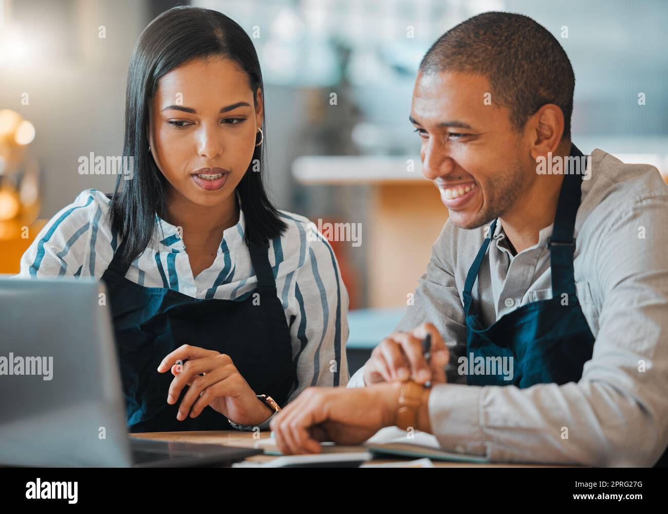 Waiter, laptop and cafe restaurant manager in small business meeting