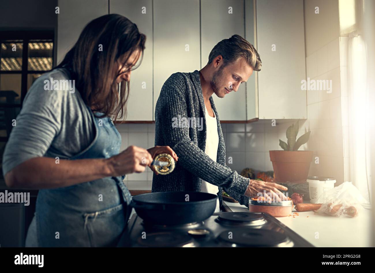 Mom and son in aprons play with flour while cooking at home in the kitchen  against the background of kitchen utensils. Selective focus. Portrait. Clos  Stock Photo - Alamy