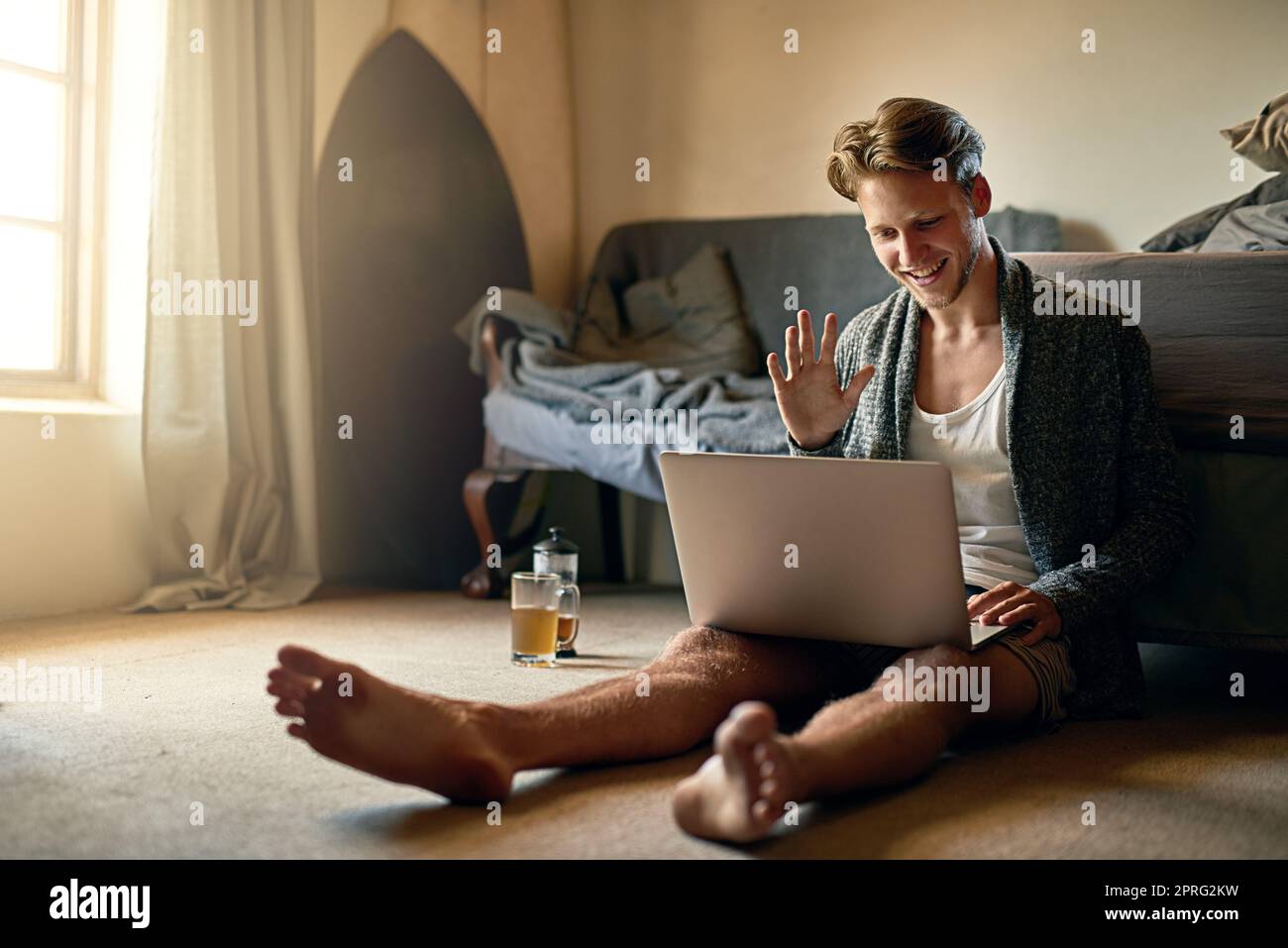 Stay close and connected to those you care about. a young man making a video call on his laptop at home. Stock Photo