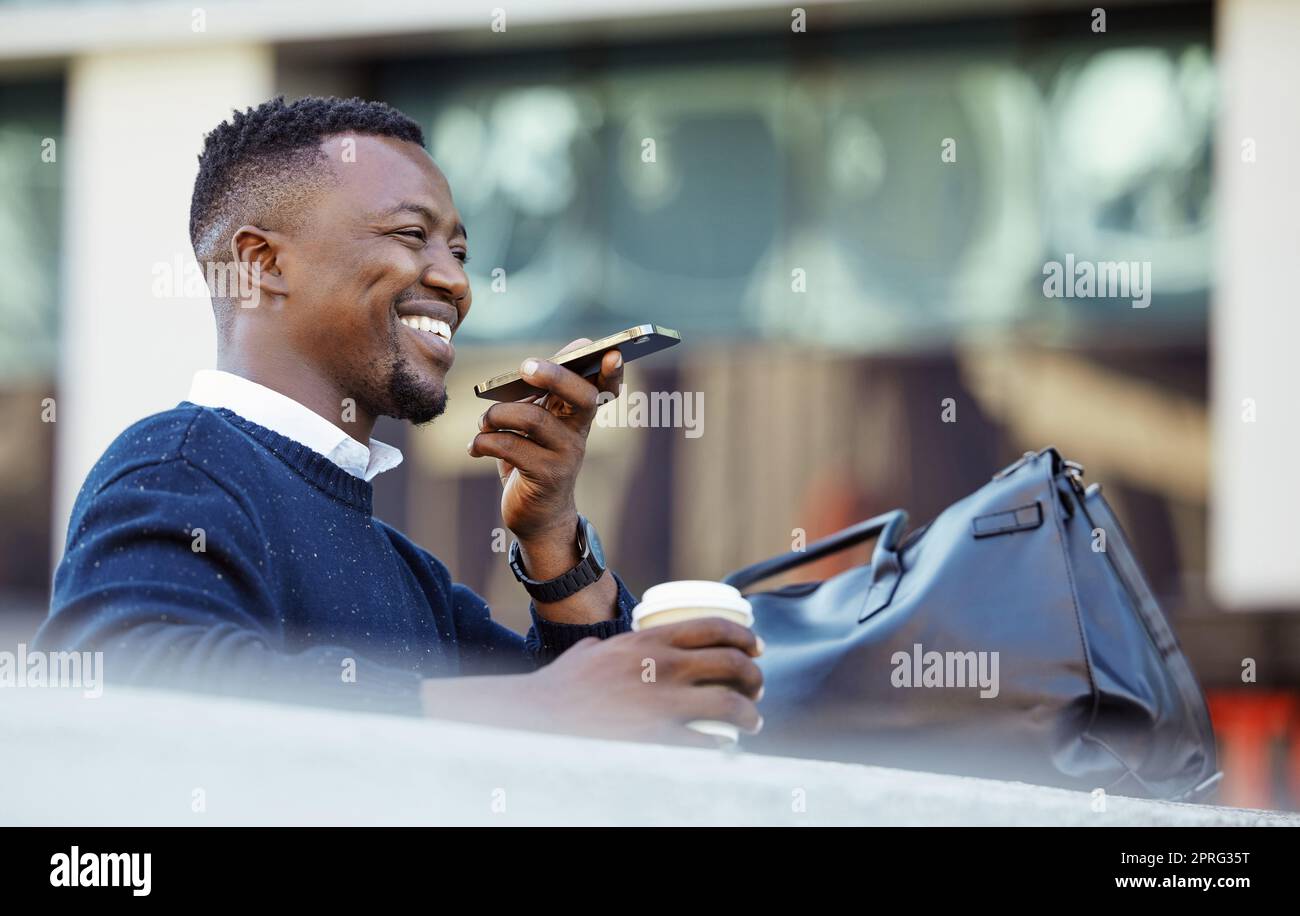 Happy black man talking on phone, travel for business in a city, sitting outside while using tech to communicate. Carefree African American planning, asking Siri assistance, voice to text audio memo Stock Photo