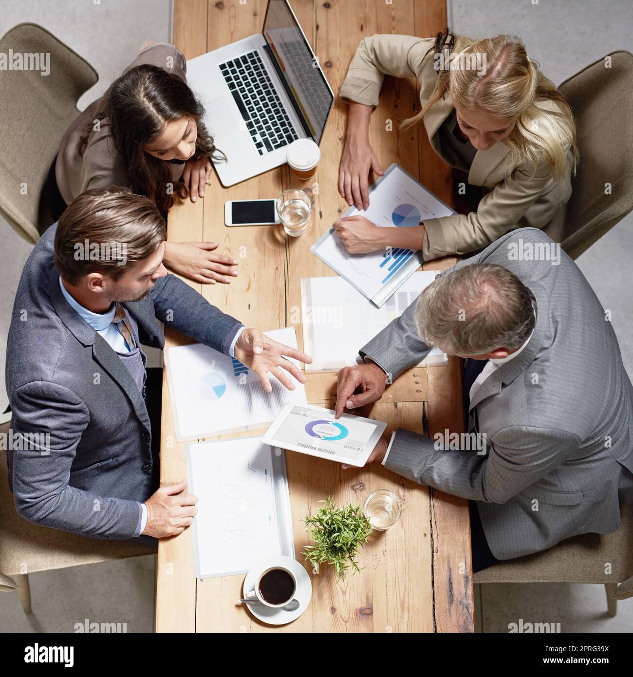 Successful collaborations makes for successful business. High angle shot of a group of businesspeople having a discussion in an office. Stock Photo