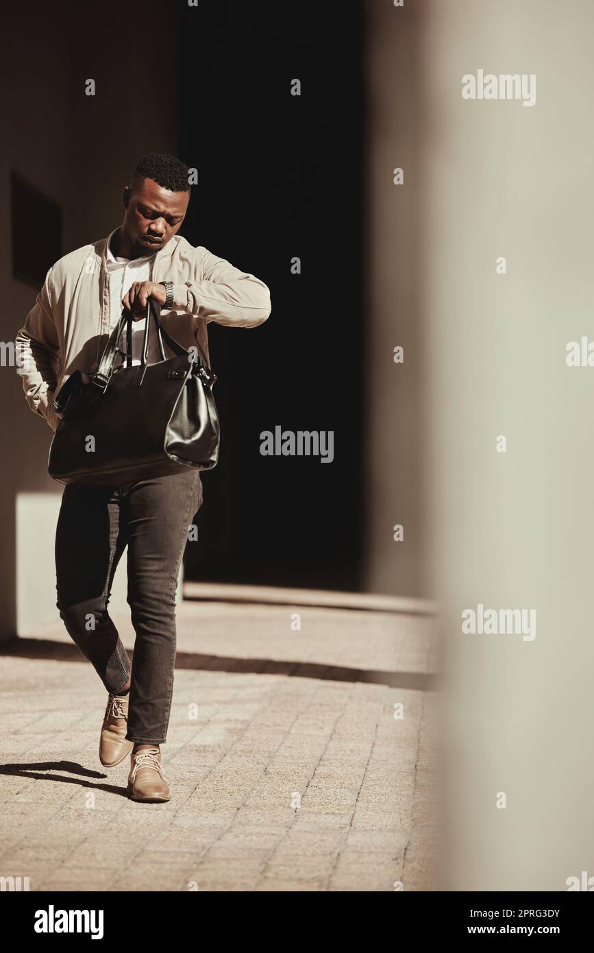 A watch, time and a business man late to a deal or meeting with a bag in the city. Busy black male worker, walking or travel or journey or rushing to a bus or plane for corporate business trip Stock Photo