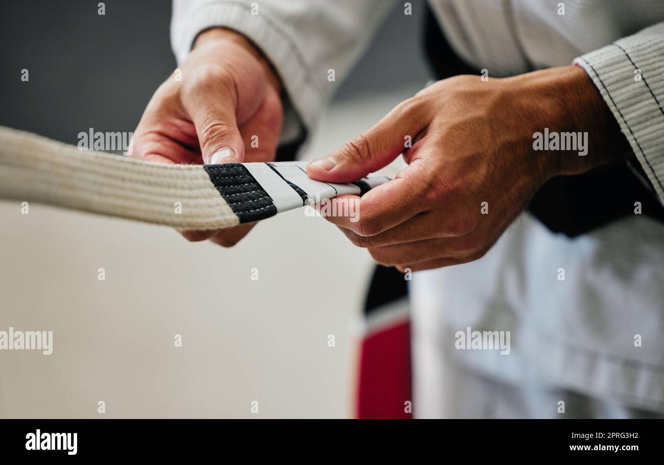 .Fitness, training and karate teacher hands prepare uniform for new