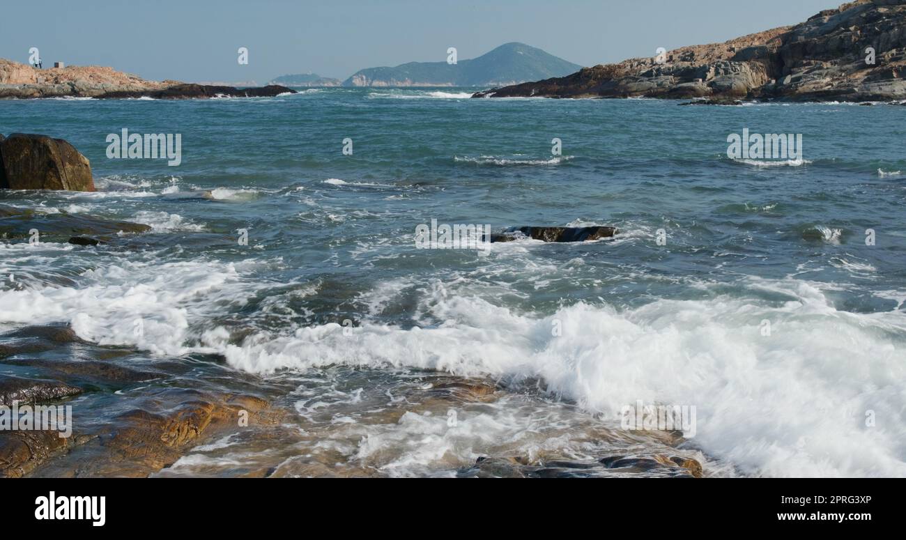 Sea waves splash against rock on island Stock Photo - Alamy