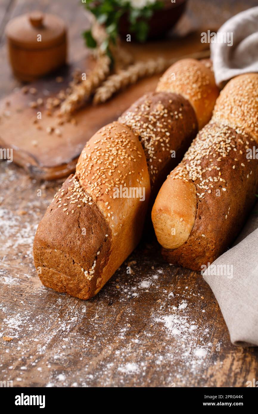 Close up of multigrain buns on wooden table in rustic style. Stock Photo